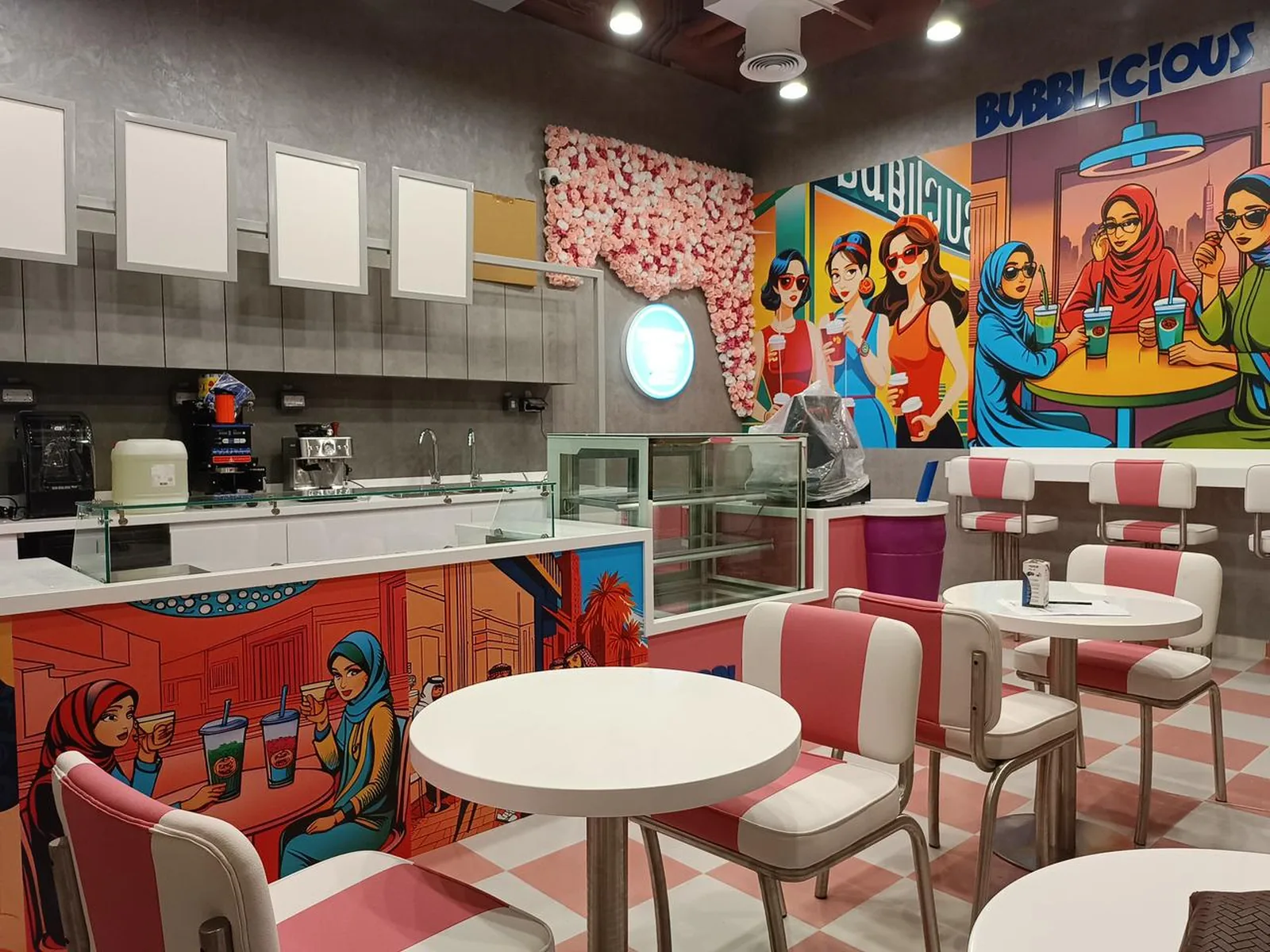 Finished café and dessert-bar fitout with custom murals and retro seating
