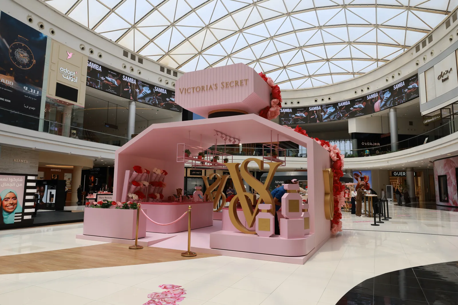 Branded pavilion launch in a shopping mall atrium with guests tasting and browsing